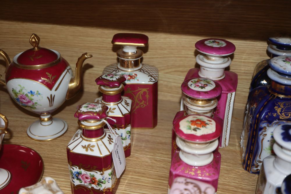 A collection of French porcelain scent bottles and a teapot (24)